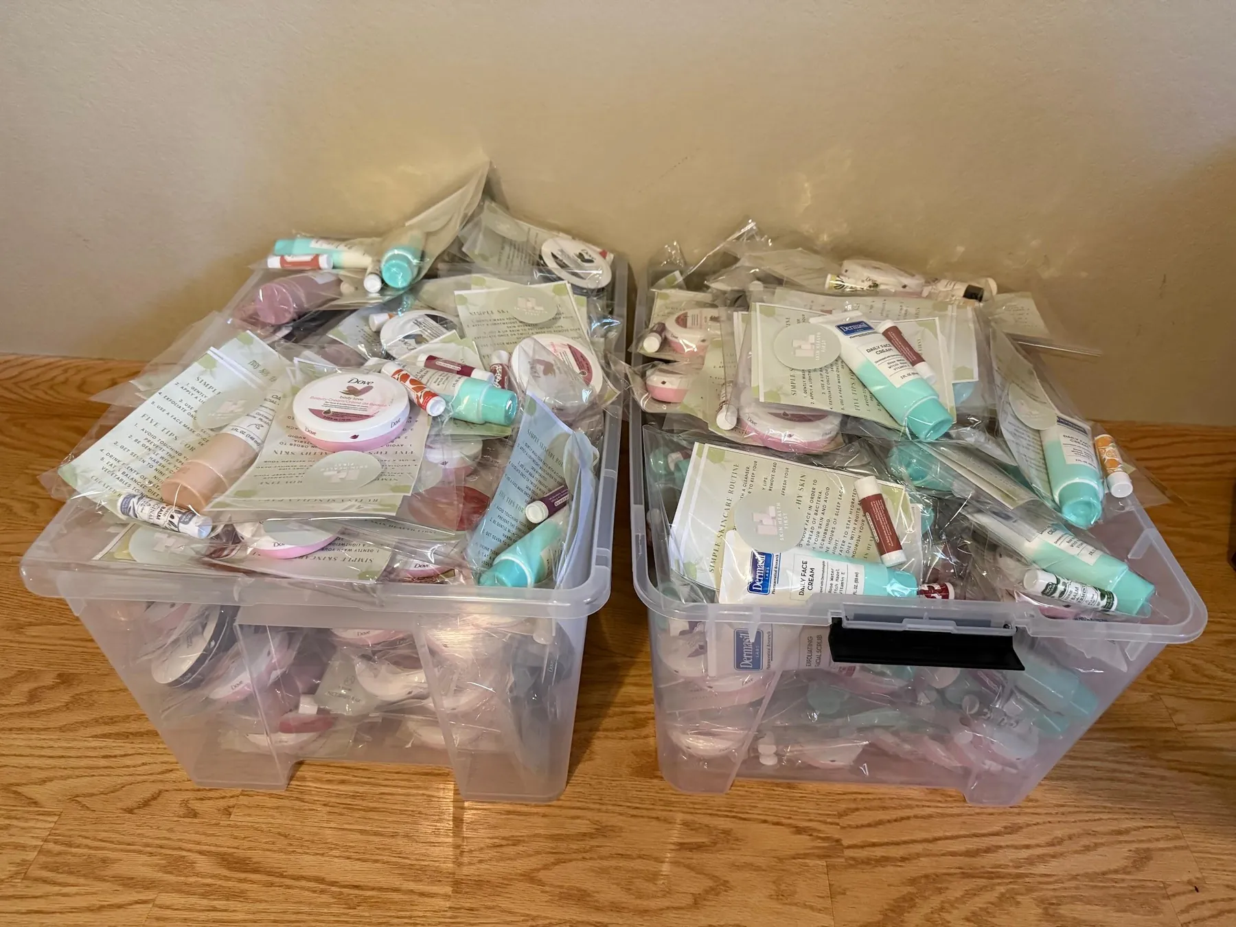 Bins filled with assembled skincare kits ready for distribution.