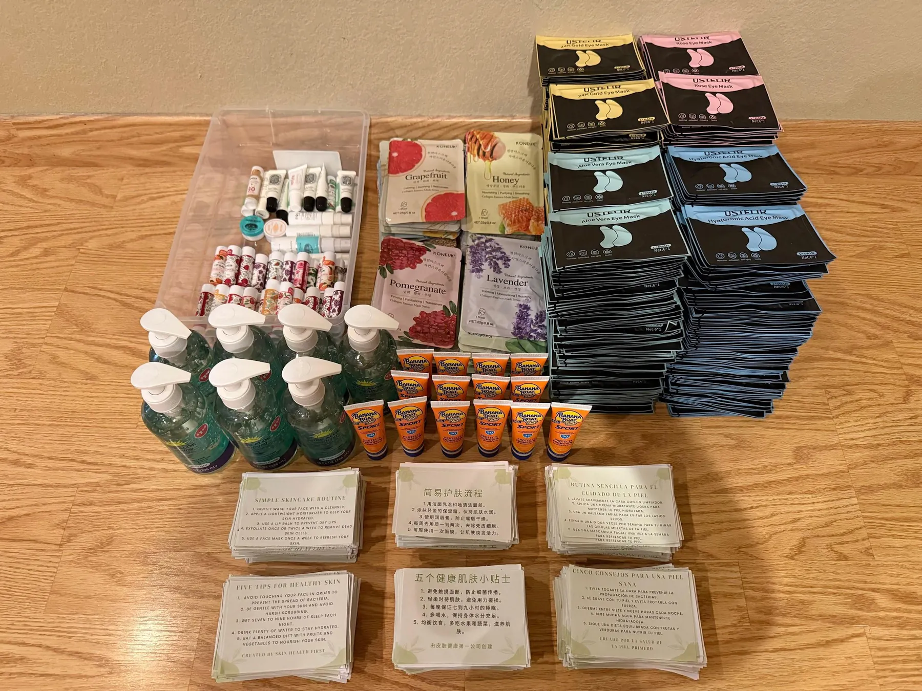 Sunscreen, eye masks, and printed skincare guides sorted for kits.